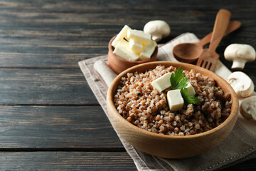 Concept of tasty eating with buckwheat on wooden table