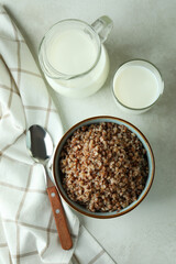 Concept of tasty eating with buckwheat on white textured table