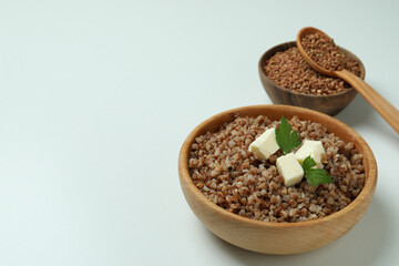 Concept of tasty eating with buckwheat on white background