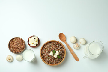 Concept of cooking buckwheat on white background