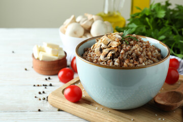 Concept of tasty eating with buckwheat on wooden table