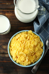 Concept of tasty breakfast with cornflakes on wooden table