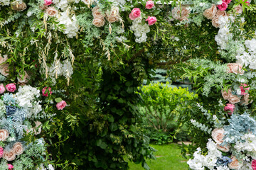 Ceremony wedding arch decorations. Outdoor ceremony in the open air with bouquets of flowers.