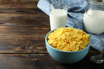 Concept of tasty breakfast with cornflakes on wooden table