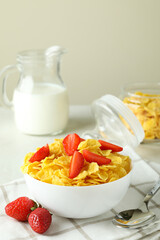 Concept of tasty breakfast with cornflakes on white textured table