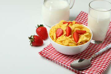 Concept of tasty breakfast with cornflakes on white background