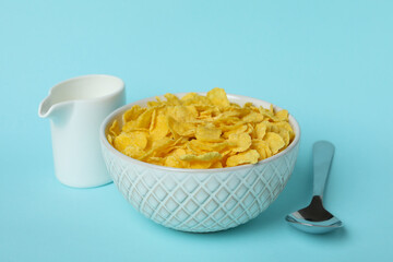 Concept of tasty breakfast with cornflakes on blue background