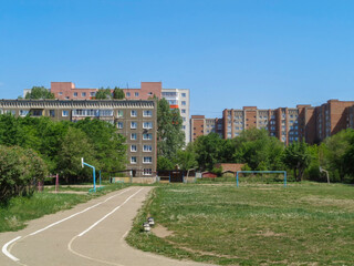 Apartment buildings. Ust-Kamenogorsk (Kazakhstan). Cityscape. Urban architectural background. Old and new residential buildings. Old residential area. Green trees