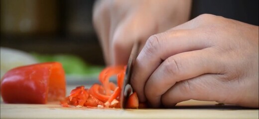 Obraz na płótnie Canvas chef cutting pepper