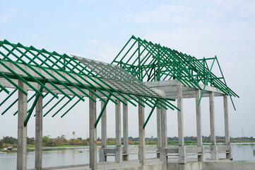 A new build roof with a metal truss framework , color green