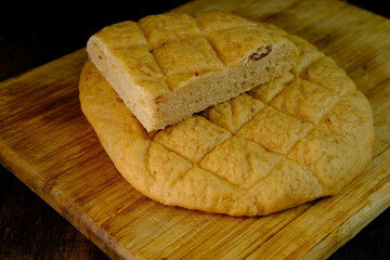 ruddy Focaccia bread, Italian wheat flatbread with dried tomatoes and sesame, healthy food concept,...