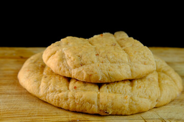 ruddy Focaccia bread, Italian wheat flatbread with dried tomatoes and sesame, healthy food concept, hearty traditional food