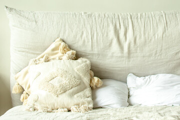 Beige and white pillows. Photo taken with selective focus and noise effect.