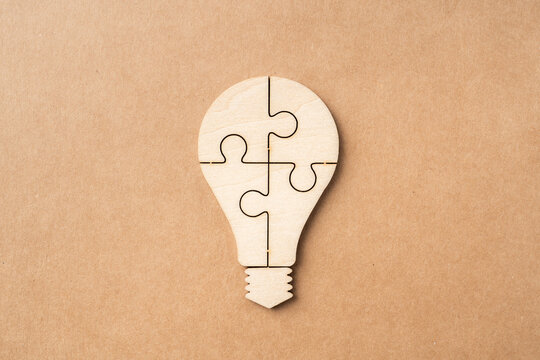 wooden businessman and light bulb, idea concept