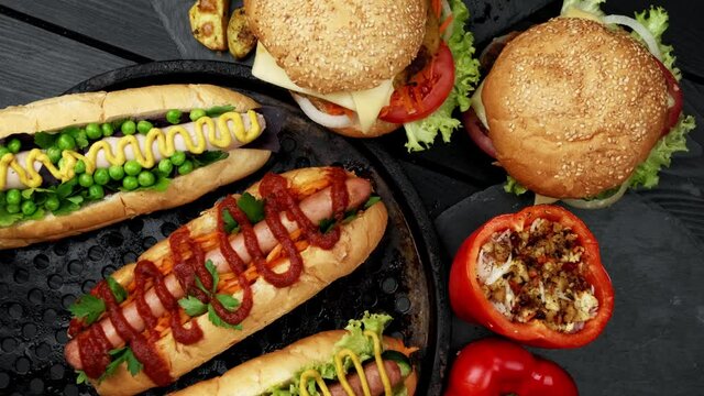 Vegeterian hot dogs served with tomatoes, avacado, onion and buns over wooden background. Top view, flat lay