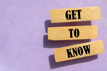 Get to know words on wooden blocks on pink background.