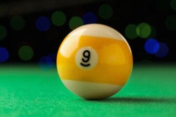 Billiard ball with number 9 on green table, closeup - obrazy, fototapety, plakaty