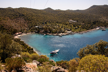 aerial view of the bay with turquoise sea water and yachts cruising along it