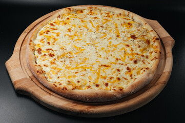 Delicious pizza Four Cheeses with cheddar, Parmesan, mozzarella and tomato sauce.