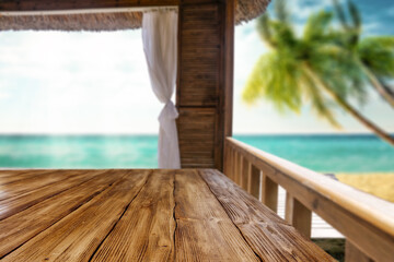 Fototapeta na wymiar Wooden desk of free space and summer background of beach 