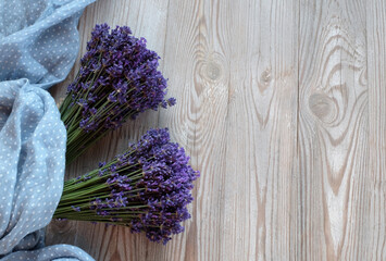 Fresh lavender on a white wooden background with a blue scarf