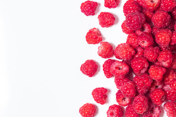 A bunch of ripe raspberries on a white background. Raspberry with copy space for text. Delicious berry