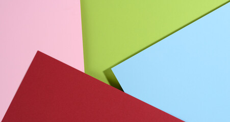 modern bright background with blue and pink, red and green sheets of paper with shadow.