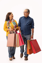 A MODERN ADULT COUPLE STANDING TOGETHER AND HOLDING SHOPPING BAGS