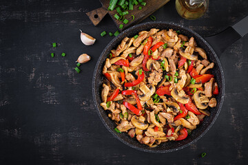 Stir fry with chicken, mushrooms and sweet peppers - Chinese food. Top view, above