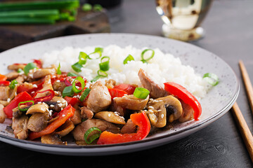 Stir fry with chicken, mushrooms, sweet peppers and boiled rice. Chinese food.