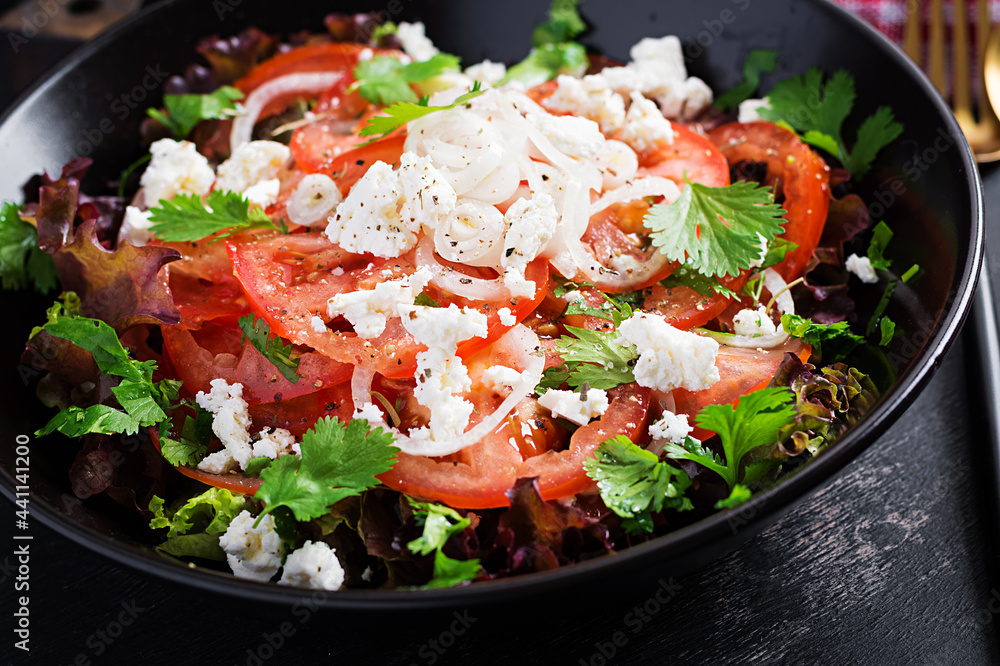 Wall mural Vegetable salad with tomato, fresh lettuce, soft cheese and onion. Healthy diet food.