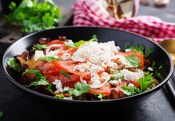 Vegetable salad with tomato, fresh lettuce, soft cheese and onion. Healthy diet food.