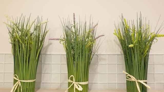 Three gren plants decor inside the bathroom with the white walls in Estonia
