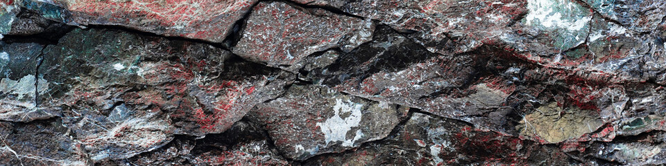 Texture of natural stone rock, background wallpaper white, gray and black splashes on the surface. Horizontal rectangular photography