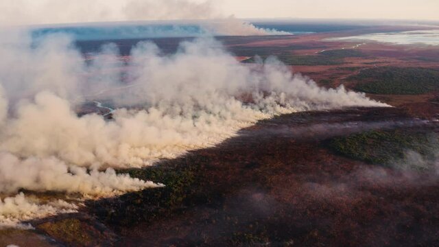 Climate emergency.Climate change. Global warming. Epic spectacular aerial view of columns of smoke billowing from a grass fire caused by drought and climate change