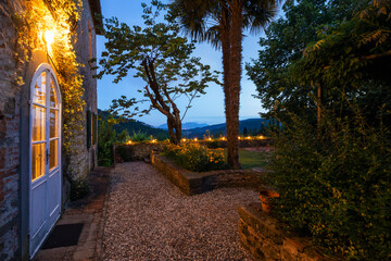 House or cottage at sunset with a beautiful garden in Tuscany. The place is romantic and makes you...