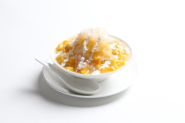 chilled fresh mango fruit sago ice snow kacang sweet dessert with coconut milk cream in white bowl