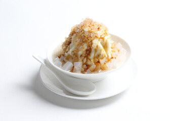 chilled soya pudding jelly with sea coconut sago ice snow kacang and brown sugar syrup in white bowl sweet dessert menu