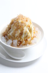 chilled soya pudding jelly with sea coconut sago ice snow kacang and brown sugar syrup in white bowl sweet dessert menu