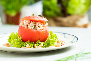 stuffed tomato with North Sea shrimp, served on a classic dinner plate. classic Belgian cuisine. 