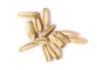 Peeled oat grains, groats pile isolated on white background, macro top view