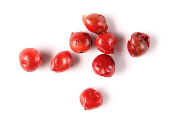 Red peppercorn pile isolated on white background, top view macro