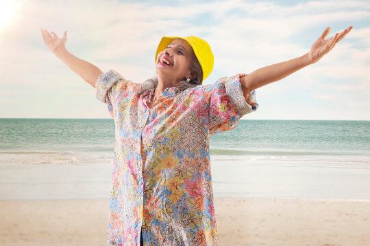 An Old Woman Sunbathing On The Beach