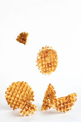 Belgian traditional waffles, creative composition on a light background. Levitating waffles. Minimalism style, selective focus, copy space.