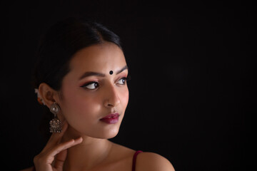 Fototapeta premium Portrait of a beautiful woman Against Black background
