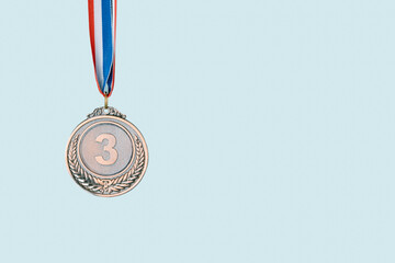 bronze medal on blue background.award and victory concept.copy space