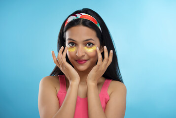 Fototapeta premium portrait of attractive girl applying Cream on her face