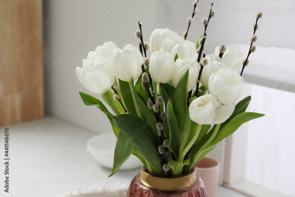 Sticker Beautiful bouquet of willow branches and tulips in vase indoors, space for text