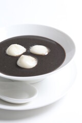 chef cook thick black sesame sweet soup with peanut glutinous rice ball hot sweet traditional dessert menu