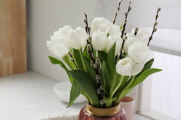 Beautiful bouquet of willow branches and tulips in vase indoors, space for text